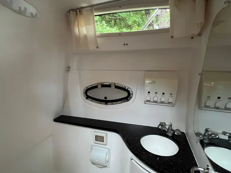 Slide: The Image of 2013 Regal 30 Express bathroom with sink, mirror, and window. - 31