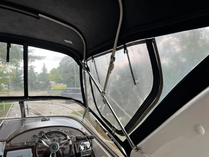 Slide: The Image of Interior view of 2013 Regal 30 Express boat cockpit with steering wheel and windows. - 41