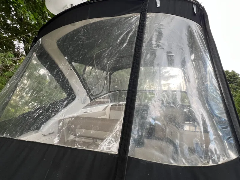 Slide: The Image of 2013 Regal 30 Express boat with clear canopy, showcasing interior seating. - 42