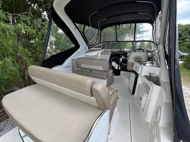 Slide: The Image of 2013 Regal 30 Express boat interior with seating and helm, featuring a sleek design. - 6