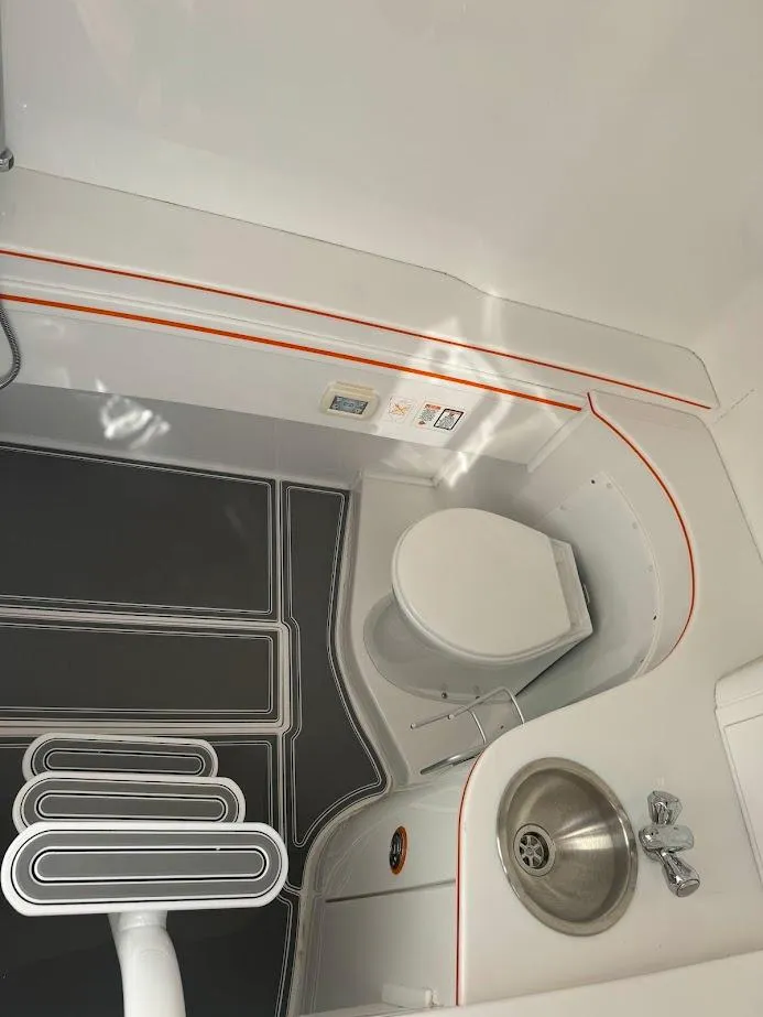 Slide: The Image of 2015 Deep Impact 399 Cabin bathroom with toilet and sink, featuring modern design. - 42