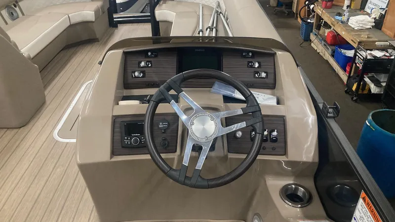 Slide: The Image of 2022 Bennington 25 LSB boat dashboard with steering wheel and control panel. - 10