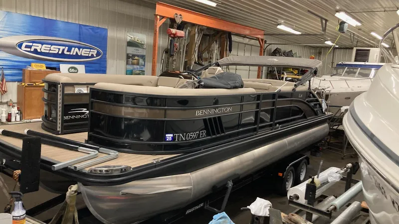 Slide: The Image of 2022 Bennington 25 LSB pontoon boat in a workshop setting. - 3
