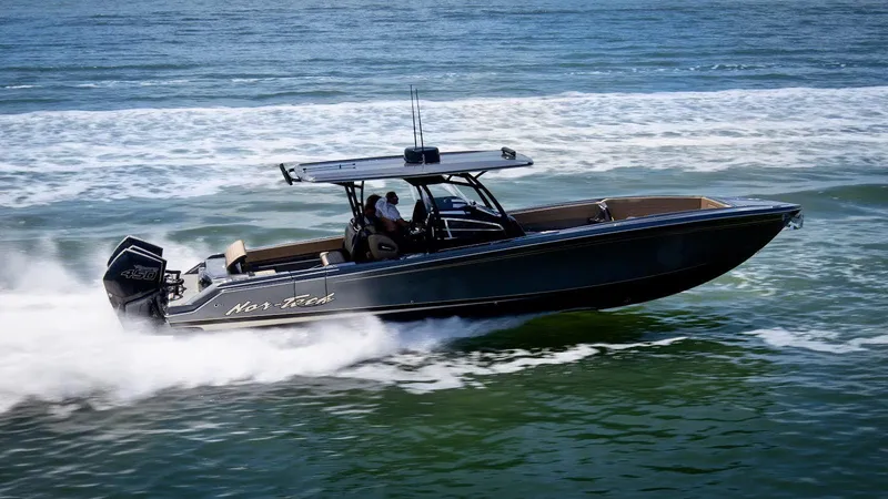Slide: The Image of 2021 Nor-Tech 390 Sport Center Console speeding on ocean waters. - 0