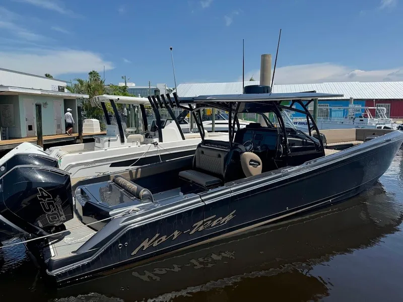 Slide: The Image of 2021 Nor-Tech 390 Sport Center Console boat docked in marina. - 1