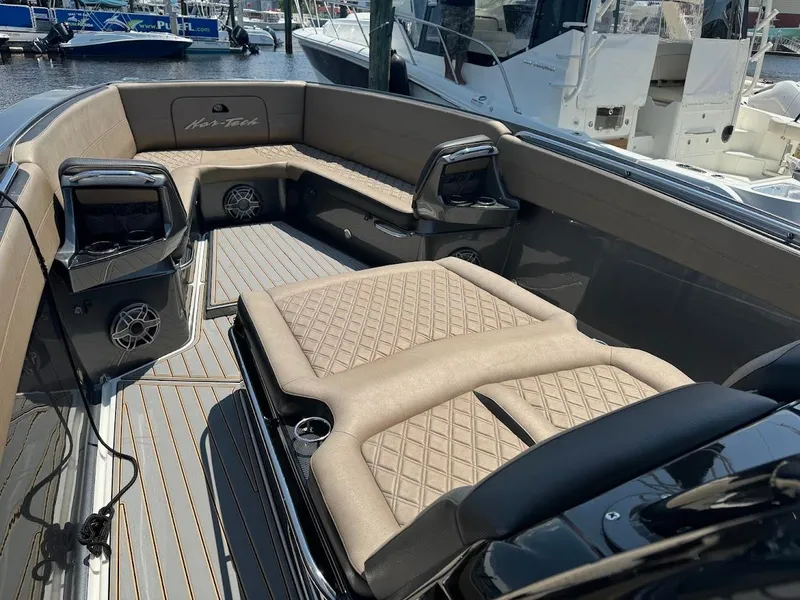 Slide: The Image of 2021 Nor-Tech 390 Sport Center Console with luxurious seating and modern design. - 2