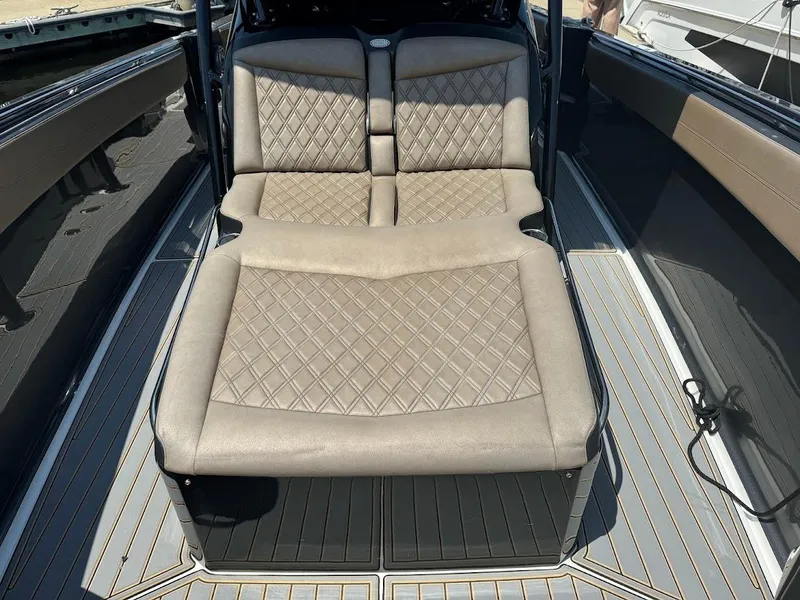 Slide: The Image of 2021 Nor-Tech 390 Sport Center Console with beige diamond-stitched seating. - 3