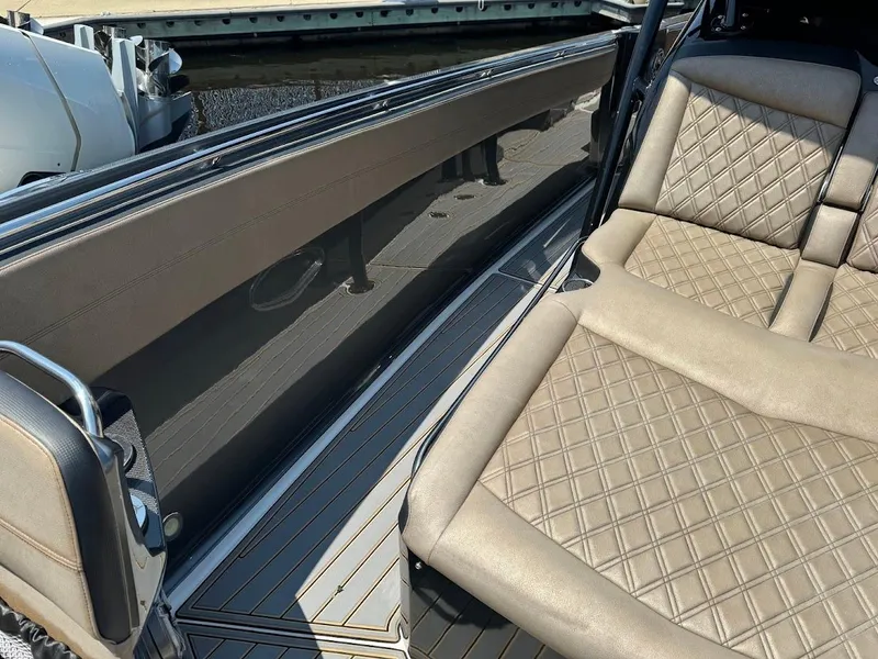 Slide: The Image of 2021 Nor-Tech 390 Sport Center Console interior with diamond-stitched seating and sleek design. - 4