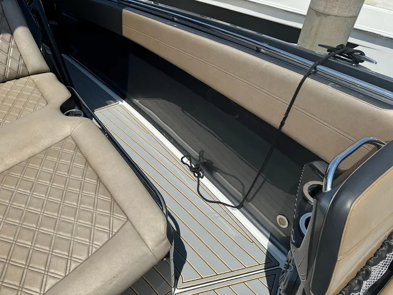 Slide: The Image of 2021 Nor-Tech 390 Sport Center Console interior with beige quilted seating and sleek design. - 5