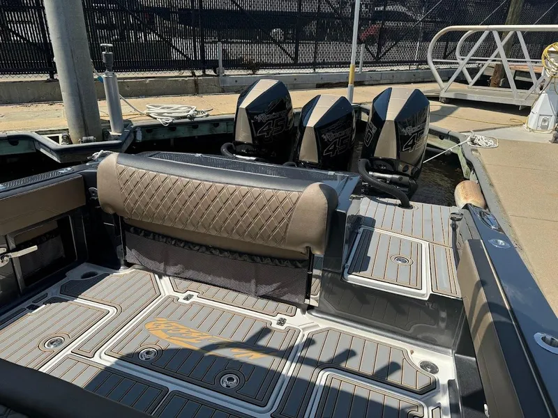 Slide: The Image of 2021 Nor-Tech 390 Sport Center Console boat with triple outboard engines at dock. - 6