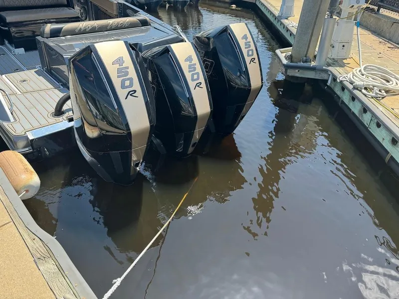 Slide: The Image of 2021 Nor-Tech 390 Sport Center Console with triple 450R engines docked in marina. - 9