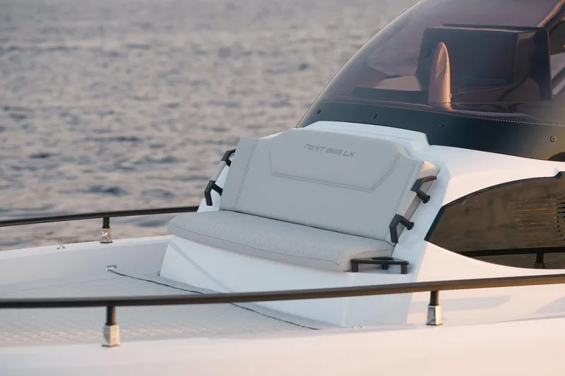 Slide: The Image of 2025 Ranieri NEXT 255 LX boat with sleek seating, cruising on calm waters. - 18
