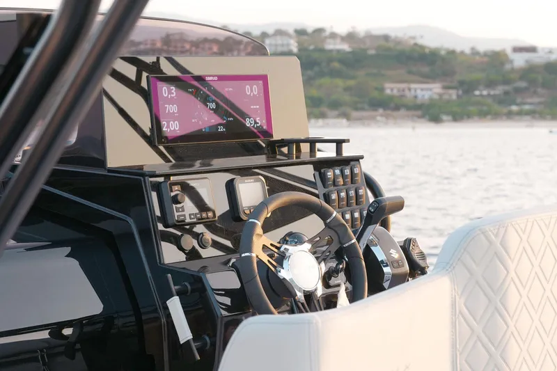 Slide: The Image of 2025 Ranieri NEXT 255 LX boat dashboard with modern controls and steering wheel. - 19