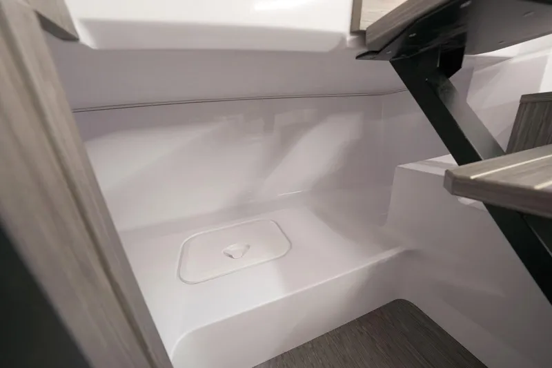 Slide: The Image of Interior view of 2025 Ranieri NEXT 255 LX boat, featuring sleek white surfaces and modern design. - 22