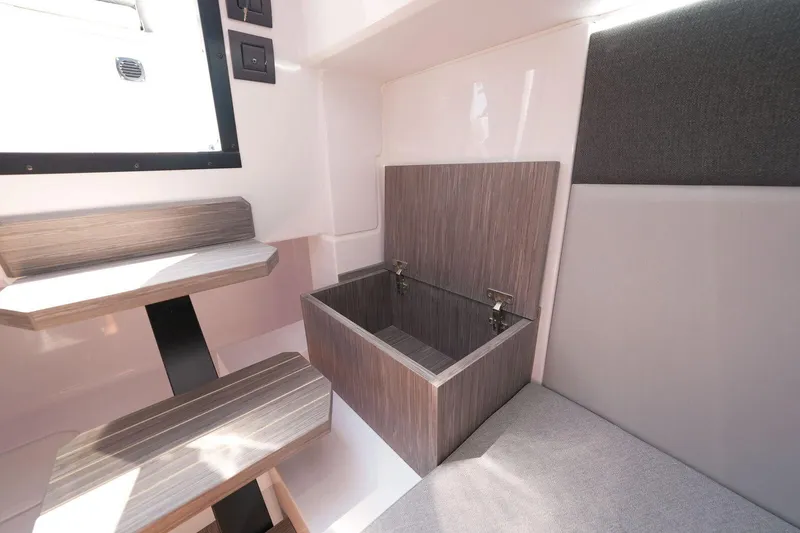 Slide: The Image of Interior of 2025 Ranieri NEXT 255 LX boat with seating and storage compartment. - 26