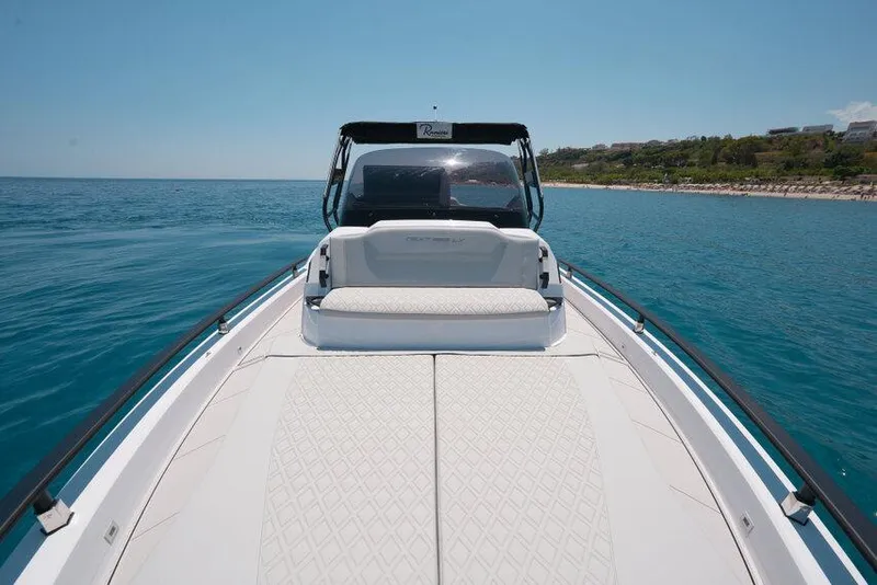 Slide: The Image of 2025 Ranieri NEXT 255 LX boat on calm sea, featuring sleek design and spacious deck. - 28