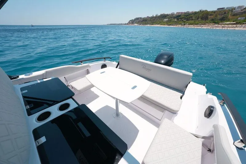Slide: The Image of Luxury seating area on 2025 Ranieri NEXT 255 LX boat, overlooking serene ocean waters. - 31