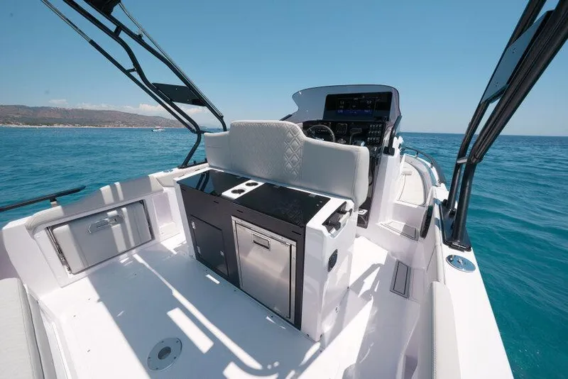 Slide: The Image of 2025 Ranieri NEXT 255 LX boat interior with modern helm and seating on open water. - 33