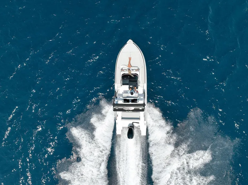 Slide: The Image of Aerial view of 2025 Ranieri NEXT 255 LX boat cruising on blue ocean waters. - 5