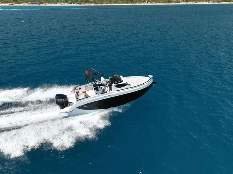 Slide: The Image of 2025 Ranieri NEXT 255 LX speedboat cruising on open blue water. - 7