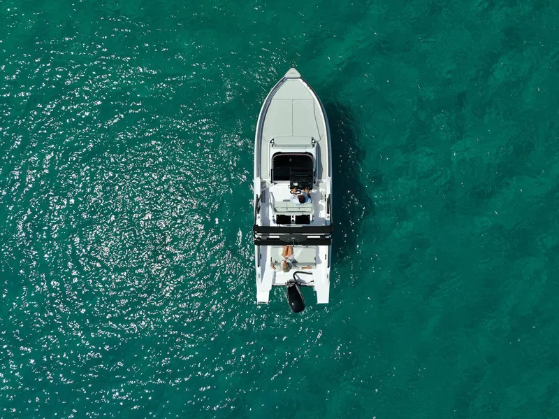 Slide: The Image of Aerial view of 2025 Ranieri NEXT 255 LX boat on turquoise water. - 9