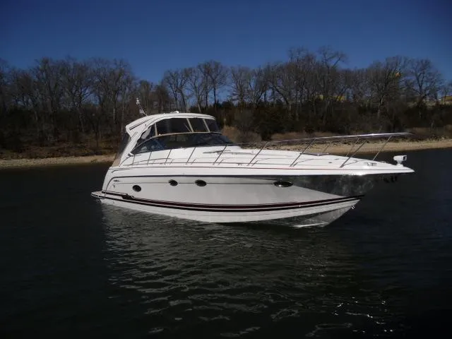 Slide: The Image of 2017 Formula 40 Performance Cruiser on calm water, with wooded shoreline in background. - 38