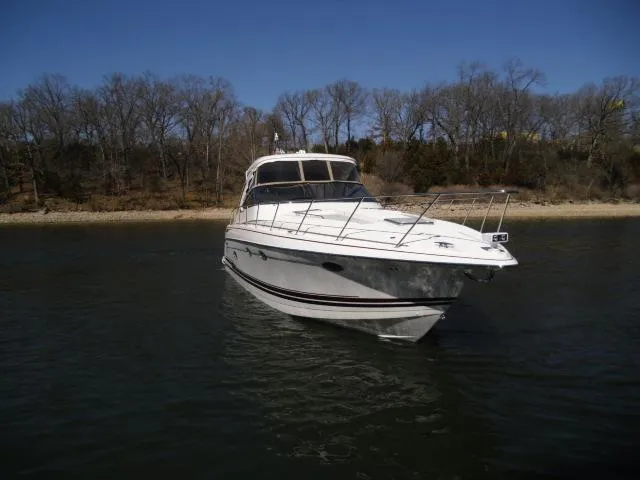 Slide: The Image of 2017 Formula 40 Performance Cruiser on calm water near a wooded shoreline. - 39