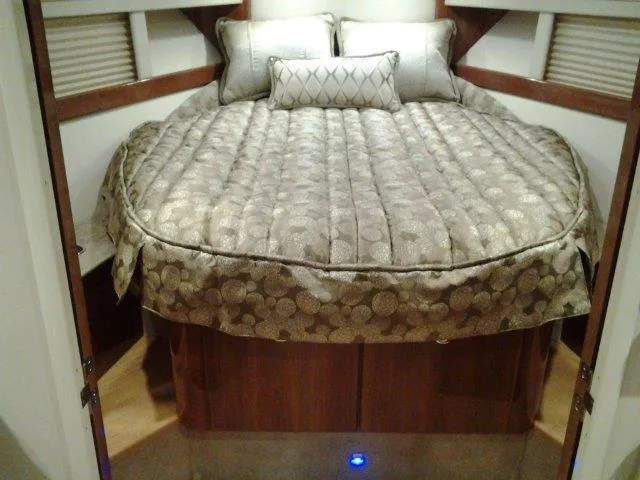 Slide: The Image of 2017 Formula 40 Performance Cruiser cabin with luxurious bedding and wood accents. - 4