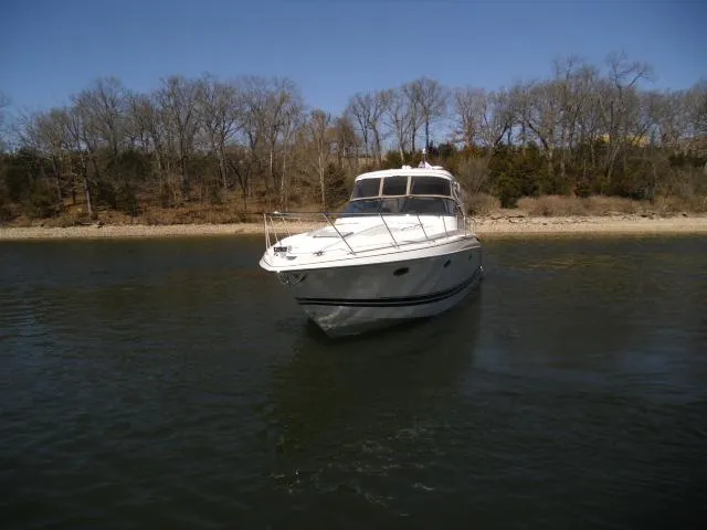 Slide: The Image of 2017 Formula 40 Performance Cruiser on calm water near a wooded shoreline. - 41