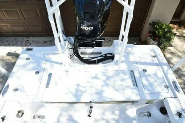 Slide: The Image of 2018 Sportsman Tournament 214 Bay Boat with powerful engine, docked outdoors. - 15
