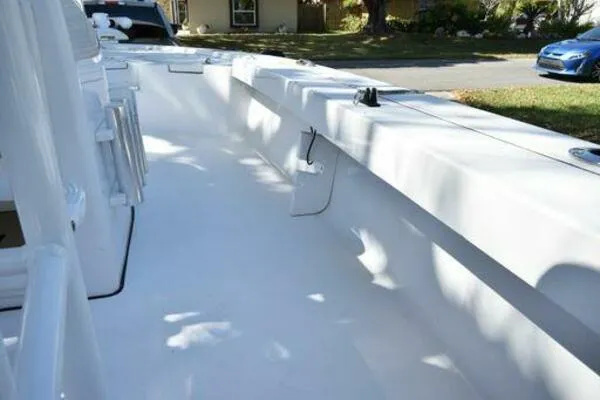 Slide: The Image of 2018 Sportsman Tournament 214 Bay Boat interior, showcasing spacious white deck and seating. - 16