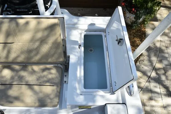 Slide: The Image of 2018 Sportsman Tournament 214 Bay Boat with open storage compartment and cushioned seats. - 23