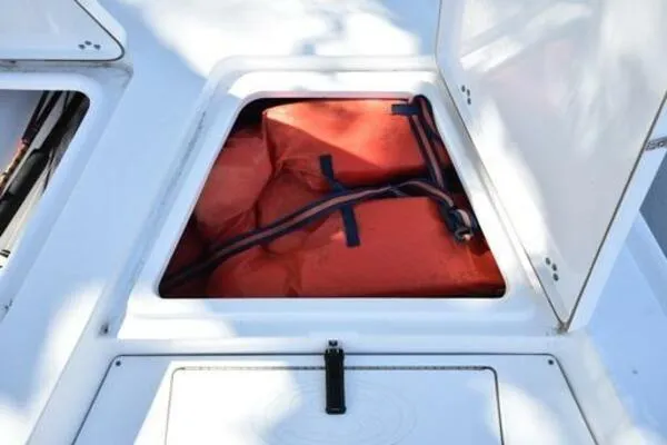 Slide: The Image of Open storage compartment on 2018 Sportsman Tournament 214 Bay Boat with orange life jackets. - 26