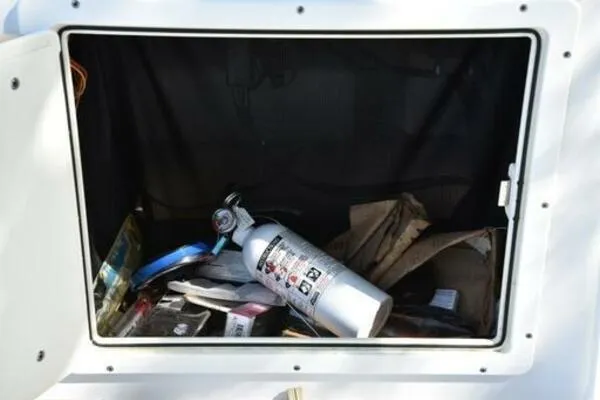 Slide: The Image of Storage compartment of 2018 Sportsman Tournament 214 Bay Boat with fire extinguisher and gear. - 27