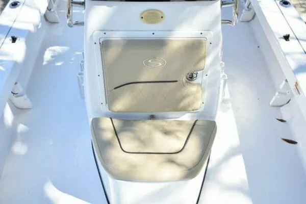 Slide: The Image of 2018 Sportsman Tournament 214 Bay Boat interior with beige seating and storage compartment. - 31