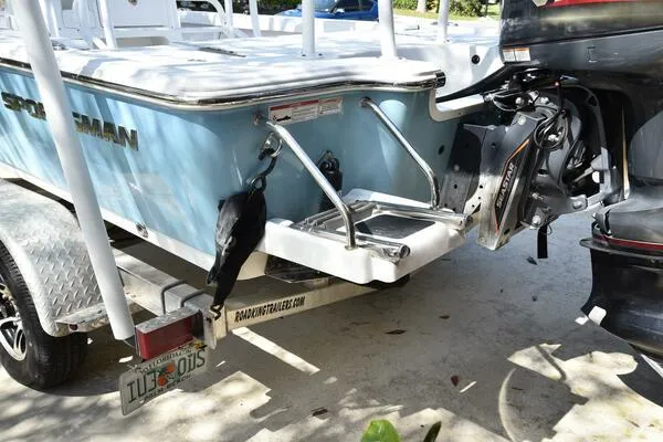 Slide: The Image of 2018 Sportsman Tournament 214 Bay Boat on trailer, rear view with motor. - 35