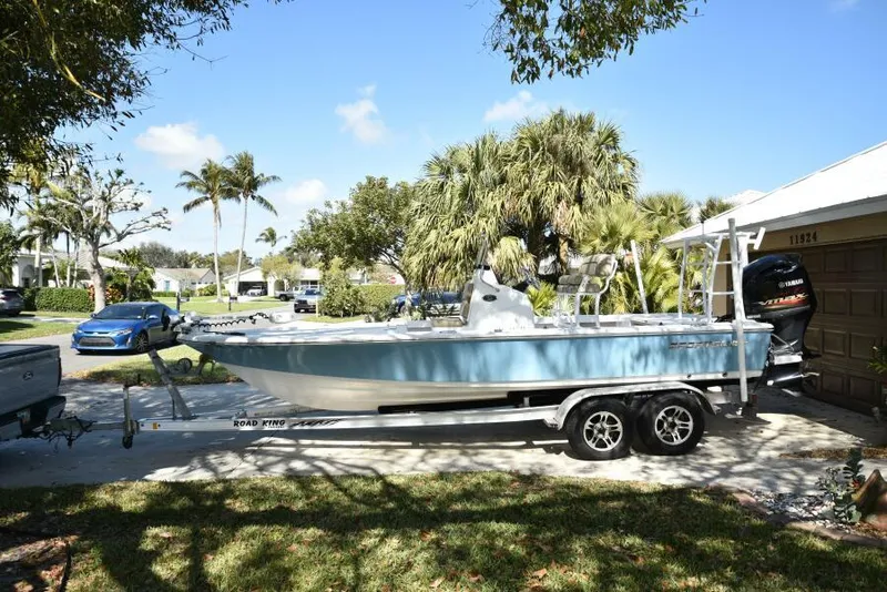 Slide: The Image of 2018 Sportsman Tournament 214 Bay Boat on trailer, parked in sunny residential area. - 37