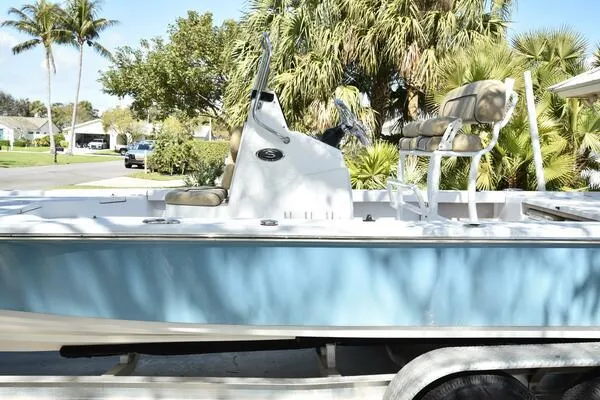 Slide: The Image of 2018 Sportsman Tournament 214 Bay Boat in a residential area, surrounded by palm trees. - 38