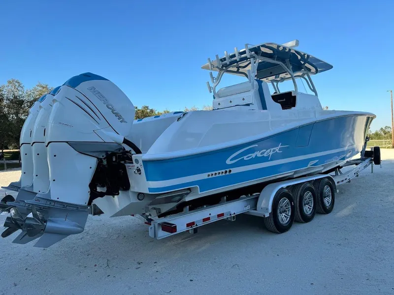 Slide: The Image of 2018 Concept 392 Family Edition boat on trailer, featuring triple outboard engines. - 13