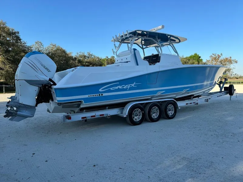 Slide: The Image of 2018 Concept 392 Family Edition boat on trailer, featuring sleek blue and white design. - 16