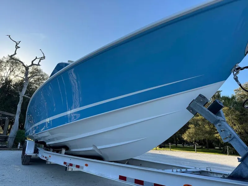 Slide: The Image of 2018 Concept 392 Family Edition boat on trailer, blue and white design, outdoor setting. - 19