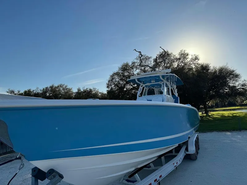 Slide: The Image of 2018 Concept 392 Family Edition boat on trailer, blue hull, sunny day. - 21