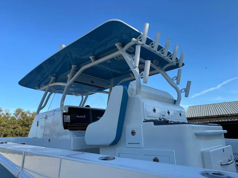 Slide: The Image of 2018 Concept 392 Family Edition boat with blue canopy and fishing rod holders. - 23
