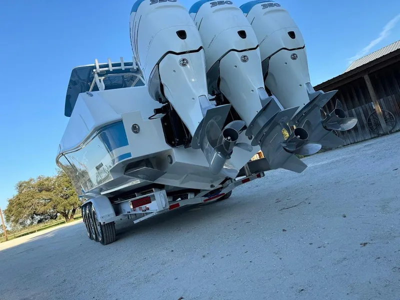 Slide: The Image of 2018 Concept 392 Family Edition boat with triple outboard engines on a trailer. - 26