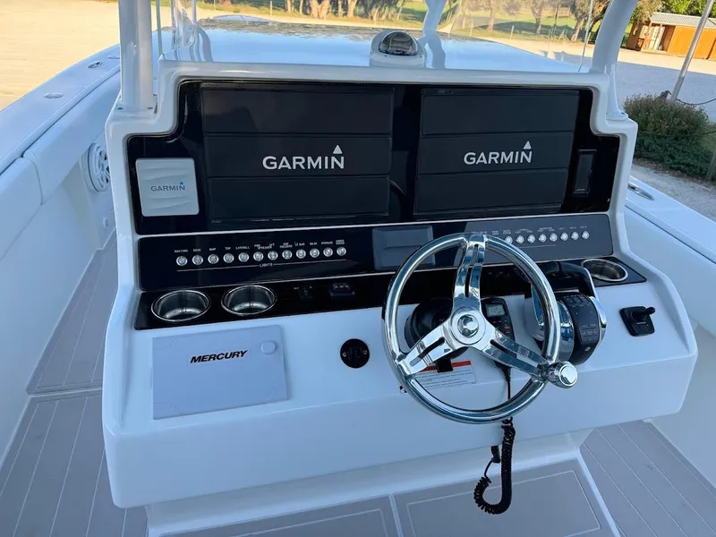 Slide: The Image of Control panel of 2018 Concept 392 Family Edition boat with Garmin displays and Mercury controls. - 27