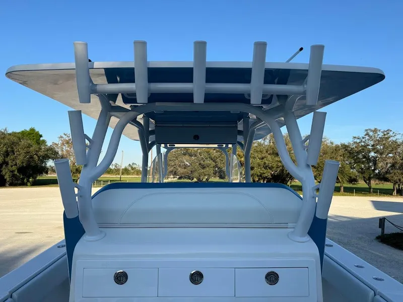 Slide: The Image of 2018 Concept 392 Family Edition boat with T-top and rod holders, parked outdoors. - 32