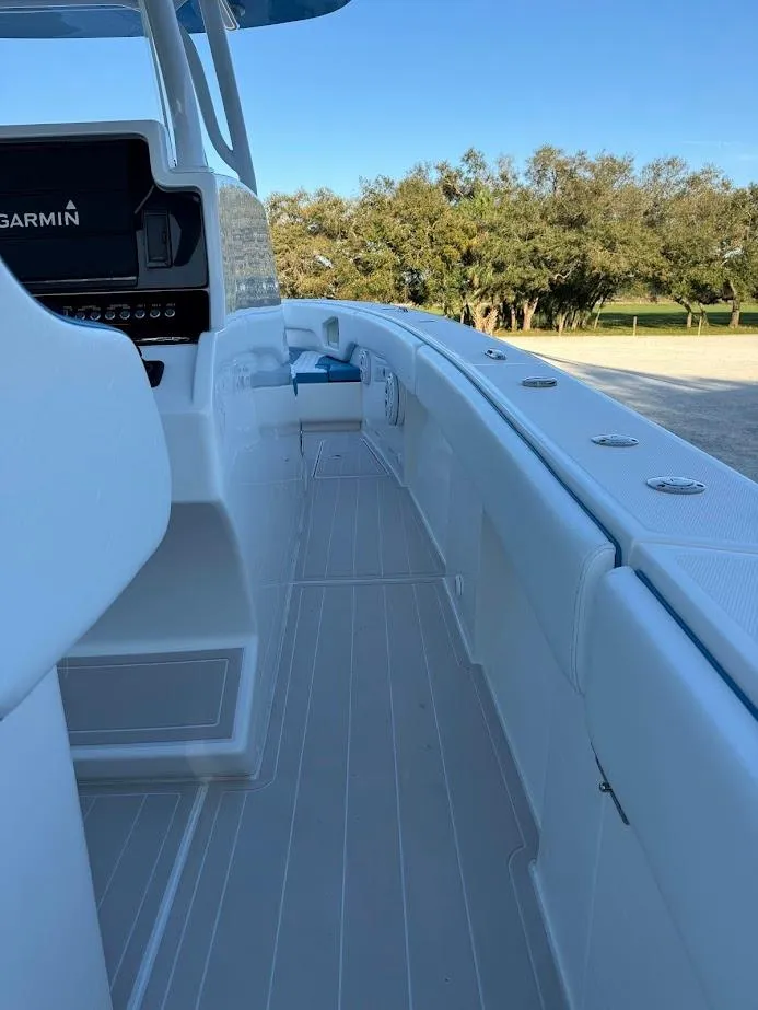 Slide: The Image of Concept 392 Family Edition 2018 boat deck with Garmin system, surrounded by trees. - 35