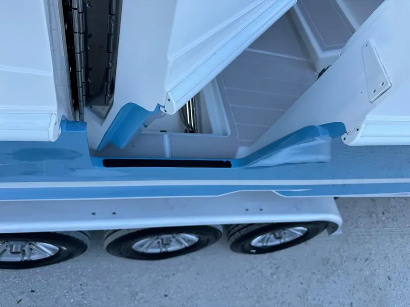 Slide: The Image of Concept 392 Family Edition 2018 boat with open storage compartment and triple-axle trailer. - 48