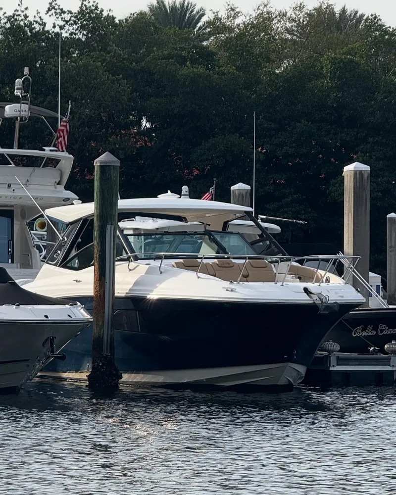 Slide: The Image of 2021 Sea Ray Sundancer 320 Coupe OB docked at marina. - 1