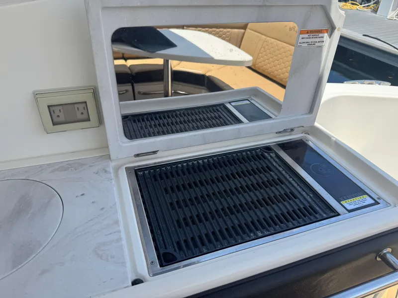 Slide: The Image of Outdoor grill on 2021 Sea Ray Sundancer 320 Coupe Outboard yacht, featuring a sleek countertop design. - 17